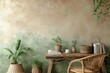 Warm and cozy composition of workspace interior with wooden desk, rattan armchair, plant in flowerpots, books, cup, beige and green wall with stucco and personal accessories