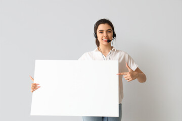 Canvas Print - Female technical support agent with blank poster on light background