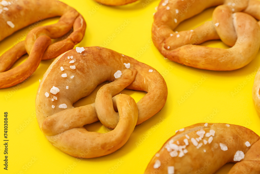 Soft pretzels on yellow background