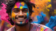 Portrait of a young Indian man stained with holi paint
