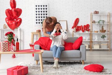 Canvas Print - Young man greeting his beloved girlfriend with Valentine's day at home