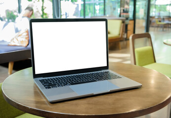 Wall Mural - Laptop with blank screen on a table in the cafe.