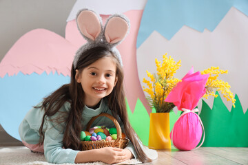 Sticker - Cute little girl with basket of Easter eggs at home