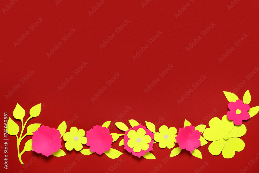Frame made of paper flowers with leaves on red background
