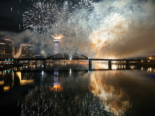 Wall Mural - Drone flight above colorful fireworks on the black sky background over-water