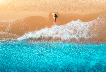 Wall Mural - Aerial view of woman on sandy beach and blue sea with waves