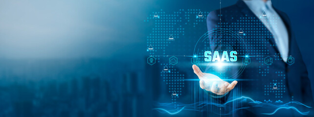 Wall Mural - saas: businessman holding software-as-a-service (saas) solutions on global technology network, scala