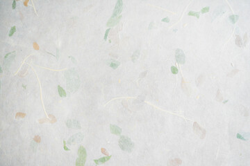 Handmade paper with pressed leaves and flower petals. Textured paper with natural fiber layers.               