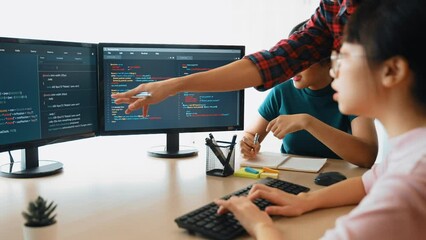 Slow motion back end software developer engineer for computer programming working together on debugging writing computing code, solving complex algorithms display on monitor in office. Burgeoning