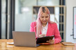 © David - Accountant asian women at desk using laptop document archives on folders papers and calculator for accounting