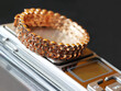 A wide gold bracelet on a scale in a pawnshop