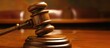 © E  - Wooden gavel and block on bench in a courtroom, symbolizing law and justice.