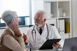 © lordn - A specialist doctor consults with an elderly female patient in his office