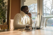 Young black man businessman portrait in an office or a cafe as he is taking a break from work