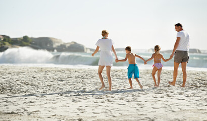 Poster - Parents, children and hand holding on beach for travel together at ocean for trip connection, bonding or love. Man, woman and siblings with back view at sea in Florida for vacation, outdoor or family