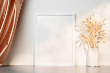 Wall Mural - Blank picture frame and dried flower in a vase on white background