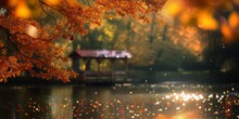 A Photo Of A Lake With A Gazebo Positioned In The Center, Surrounded By Colorful Fall Bokeh.