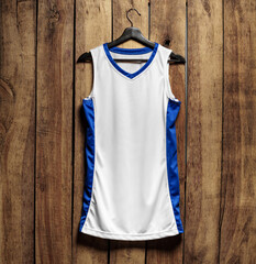 Basketball jersey on hanger against wooden background