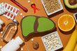 Paper mockup of liver, pills and food on orange background, top view