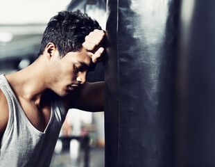 Fitness, punching bag or tired man at gym with low energy, loss or performance fail or mistake. Sports, fatigue or male boxer exhausted by intense body workout, challenge or fighting practice burnout