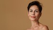 © Kate - portrait of a beautiful woman 45 years old with healthy skin on a beige background, concept of natural beauty and healthy skin