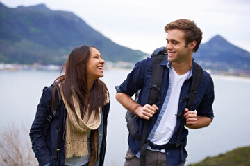 Canvas Print - Hiking, nature and couple on mountain laugh with backpack for love, trekking and explore landscape. Travel, dating and happy man and woman by scenic view on holiday, vacation and outdoor adventure