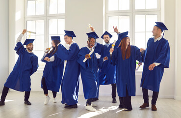 Wall Mural - Graduation happy student party formal event, young people in traditional academic gown, cap. Friends successfully complete college, university study course, commencement ceremony, awarding of diploma