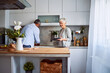 © Jelena - A lovely senior couple doing house chores together, washing and cleaning the dishes in the kitchen