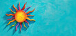 An imaginative sun with rainbow colors, against a turquoise blue background