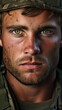 Close up portrait of handsome male soldier or marine wearing helmet with green eyes looking at camera 