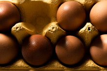 Close Up View Of Brown Eggs In Yellow Paper Box
