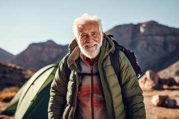 Poster - Portrait of senior man with backpack and tent in the mountains.