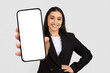© Prostock-studio - Confident businesswoman presenting blank smartphone screen