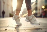 Fototapeta  - A person walking on a sidewalk wearing sneakers. Suitable for lifestyle and urban themes