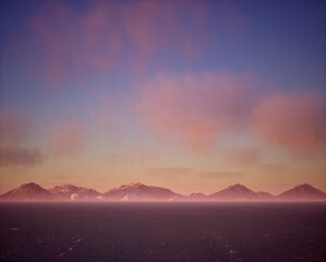 Wall Mural - Frozen lake with snow mountains in mist under sunset sky with some clouds.