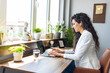 © Dragana Gordic - Woman working on laptop online, checking emails and planning on the internet while sitting in an office alone at work. Business woman, corporate professional or manager searching the internet