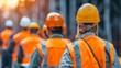 © nialyz - Team of Construction Workers at SunriseA group of construction workers in safety gear prepares for the workday at a construction site during sunrise.