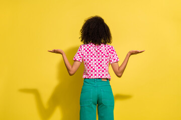 Sticker - Rear behind portrait of anonymous person hands hold weighing empty space ad isolated on yellow color background