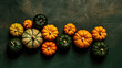 A group of pumpkins on a vivid green color stone