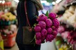 shopper with peonies bulging from purse
