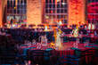 © Raivo - Riga, Latvia - February 16, 2024 - a festive event setting with tables, glowing centerpieces, and illuminated brick walls.