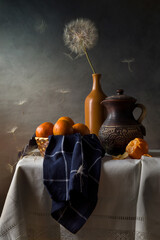 Modern still life with dandelions and tangerines on a dark background