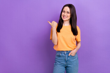 Sticker - Portrait of lovely girl with stylish hairdo wear oversize t-shirt indicating at promotion empty space isolated on violet color background