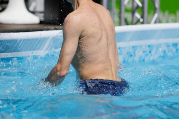 Wall Mural - Boy Doing Water Aerobics Outdoor in a Swimming Pool