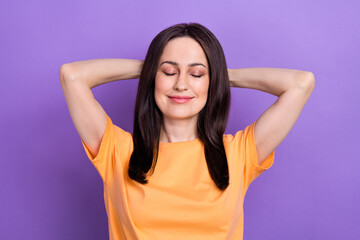 Wall Mural - Portrait of satisfied girl with stylish hair wear oversize t-shirt holding arms behind head close eyes isolated on violet color background