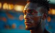 Close-up portrait of sweaty African runner at competition after 100m or 400m race in stadium on sunset