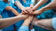 A top-down view of diverse healthcare professionals placing their hands together in a gesture of unity and teamwork. Elevated View Of Doctors Stacking Hands. AI