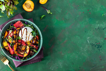 Delicious summer salad with burrata cheese and grilled peaches, arugula and microgreens.