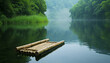 A handmade bamboo raft floats tranquilly on a calm river - reflecting the surrounding verdant scenery and clear blue skies - wide format