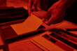 © LIGHTFIELD STUDIOS - cropped photographer skillfully prepares a film negative for photo development in darkroom